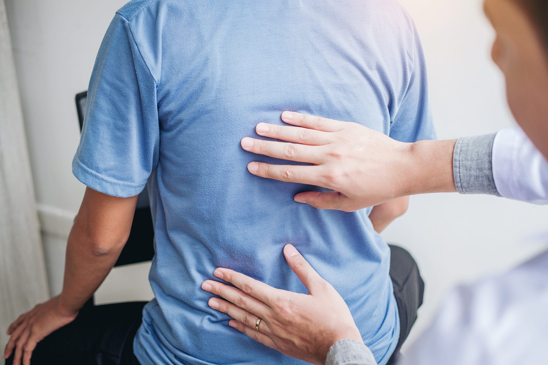 pain-management dr touching patients back